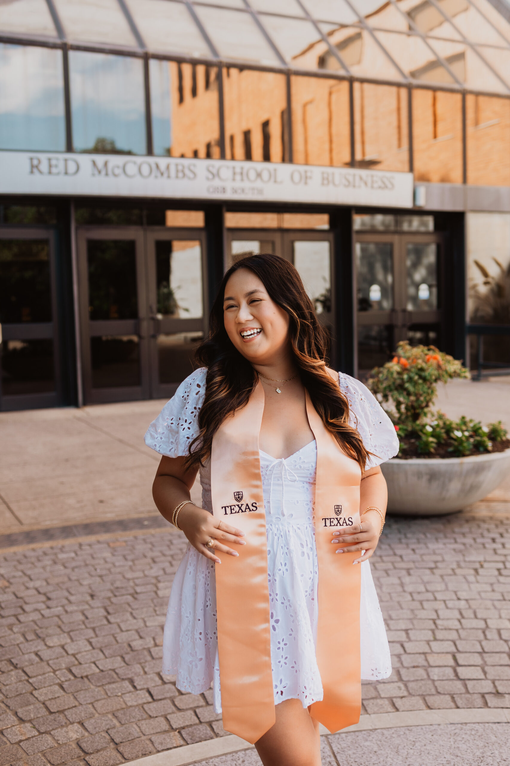 senior in front of McCombs School of Business