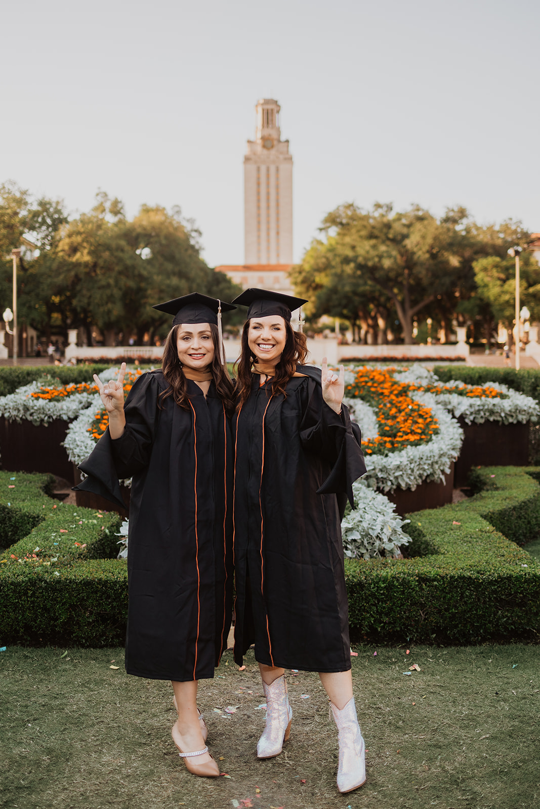 Two MBA graduate students pose in front of the Tower at UT Austin